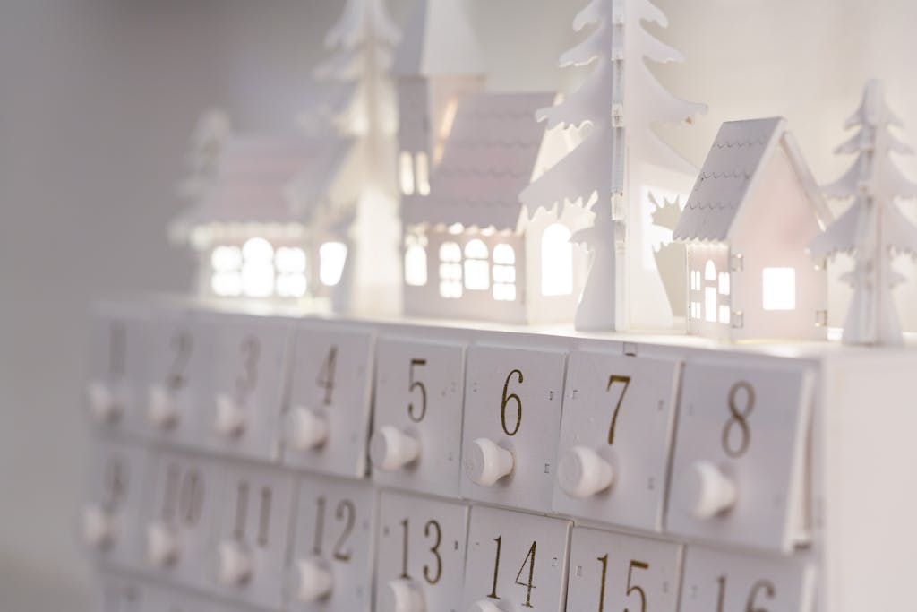 Beautiful minimalist advent calendar with illuminated houses and numbers for winter decor and festive ambiance.